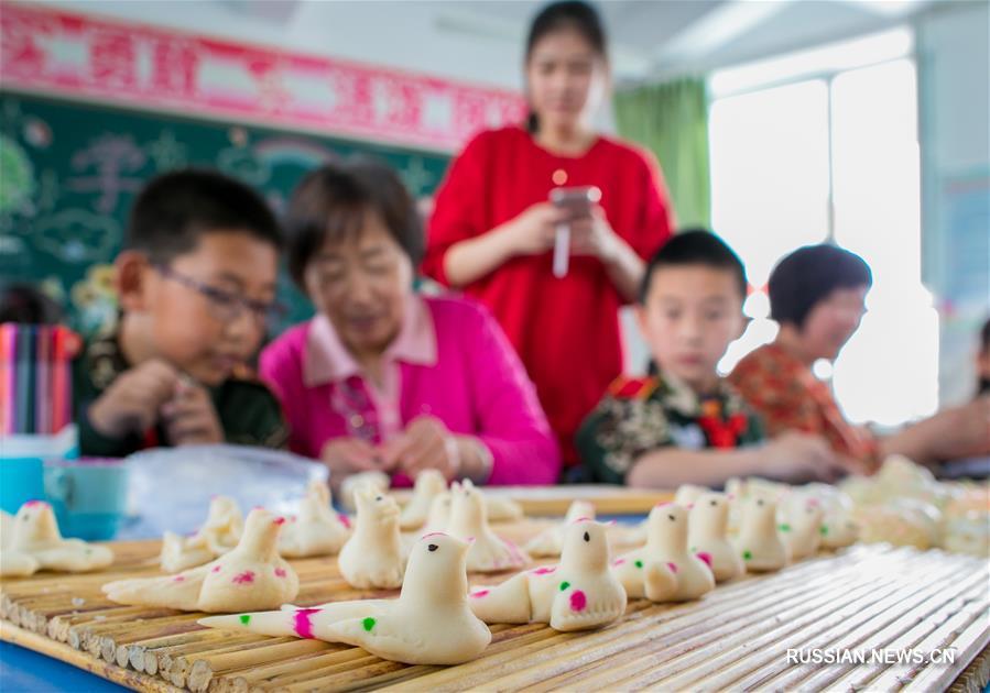 Школьники Хух-Хото учатся лепить фигурки из теста "ханьянь" на праздник Цинмин