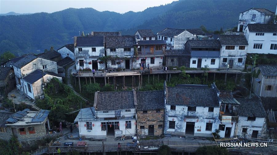 Первые лучи солнца над горной деревушкой в провинции Аньхой 